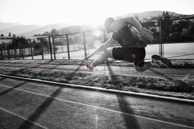 young healthy man run on athletic race sport track and representing concept of sort and speed